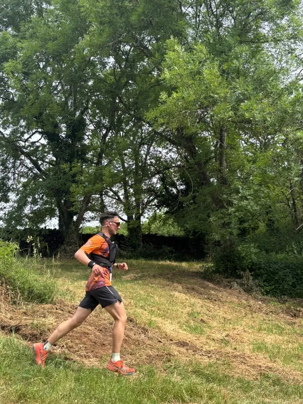 Un traileur en pleine descente dans une prairie de l'Auxois pendant le trail de 15 km